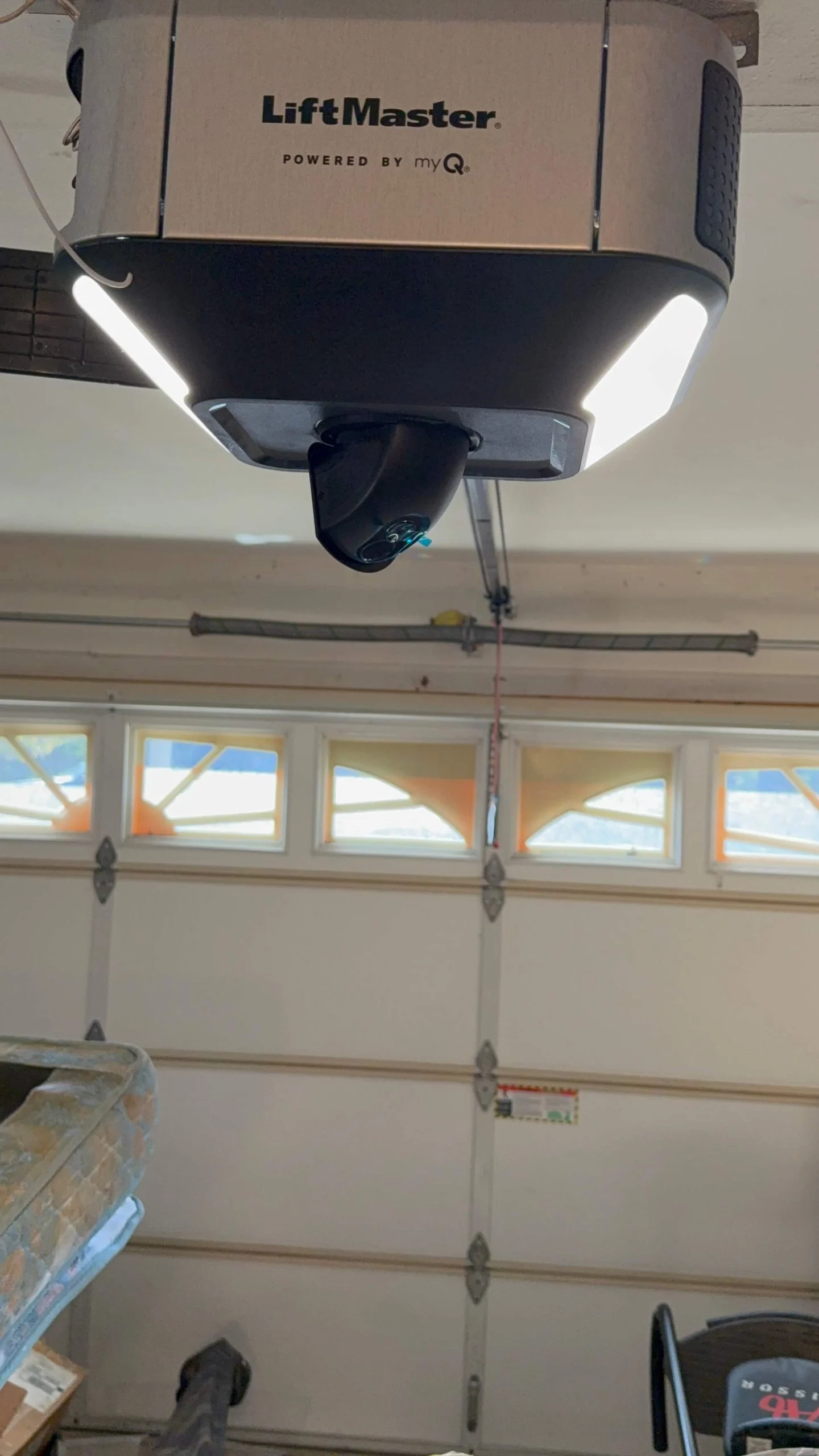 LiftMaster opener with work lights over a sectional door with windows