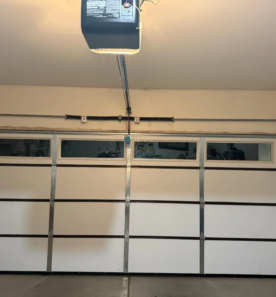 Opener with light on over a flush-panel door with a window row